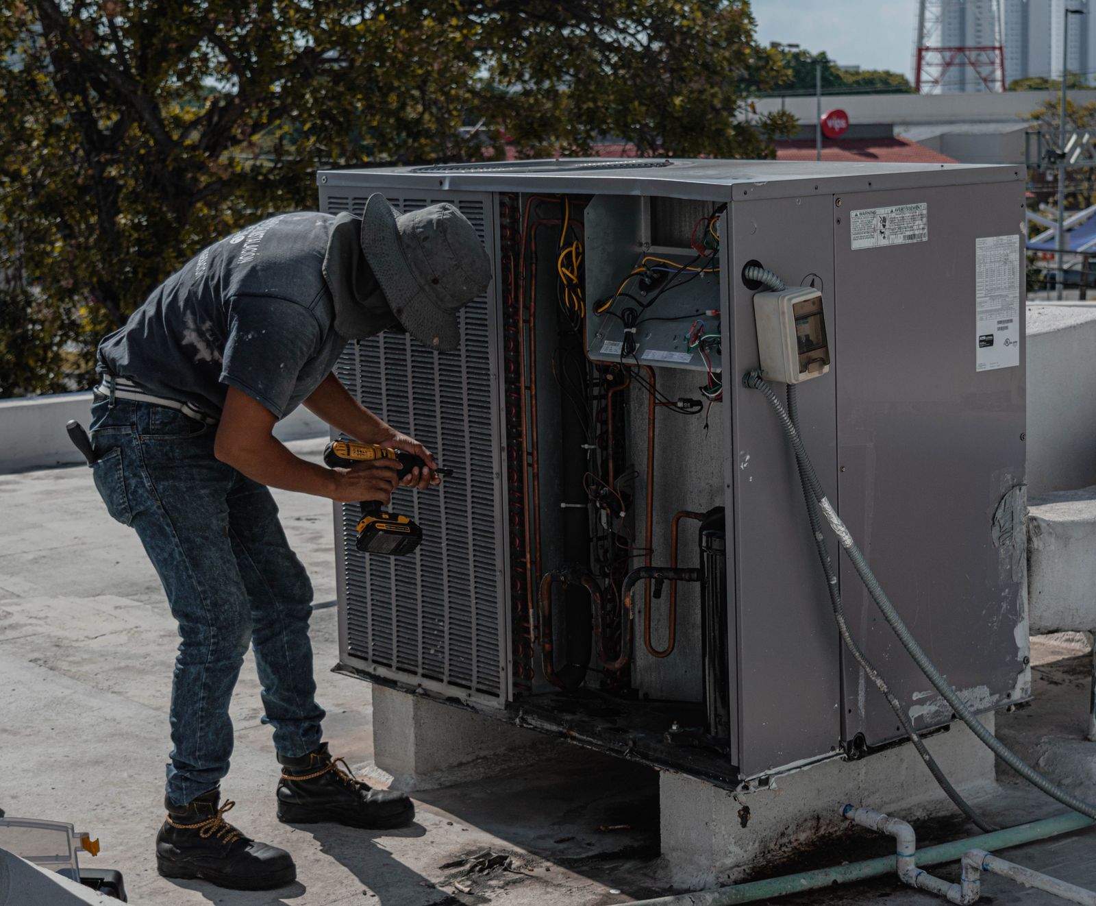 Profissional realizando manutenção em unidade externa